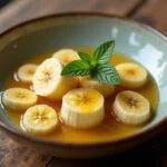Finished natural banana da Madeira dessert garnished with mint and honey, perfect for healthy eating.