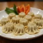 Finished massa chinesa dumplings, showcasing their smooth texture and presentation.