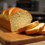 Finished pão saloio loaf with golden crust and soft interior, ideal for traditional Portuguese meals.