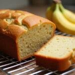 Freshly baked pão de banana displayed with slices, perfect for enjoying at home.