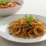 Crunchy cebola frita crocante served on a plate, perfect for enhancing meals.